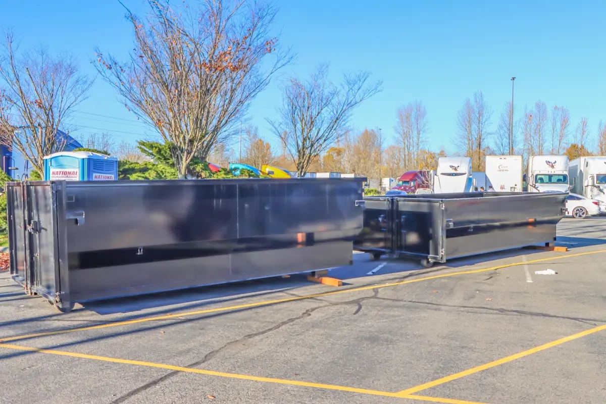 Professional dumpster rental service with roll-off container on residential driveway in Augusta